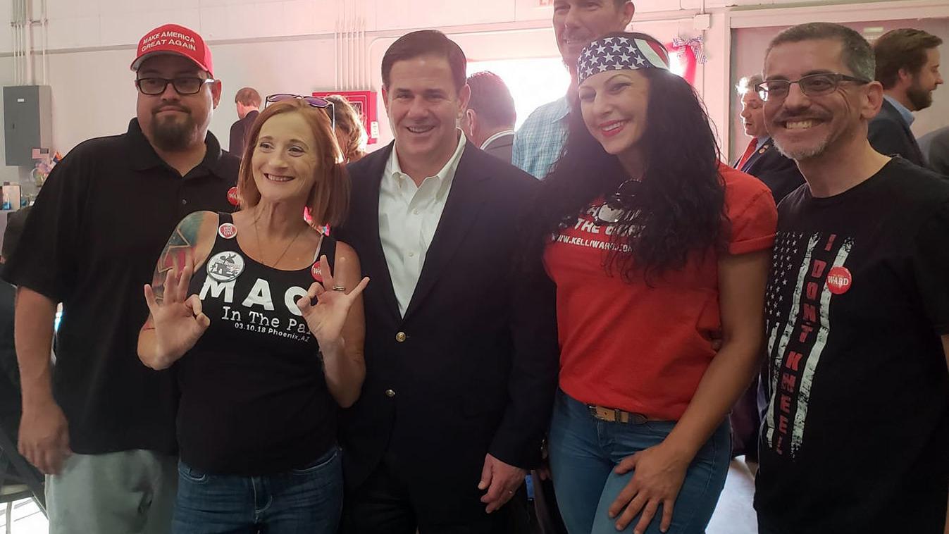 Ducey denounces controversial Arizona group after posing for photos with them